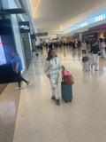 Woman wearing Floral Roo hoodie and joggers at airport