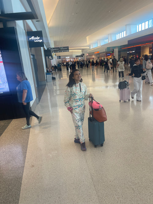 Woman wearing Floral Roo hoodie and joggers at airport